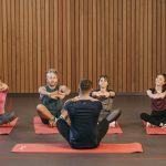 A diverse group practicing yoga in a studio with a focus on wellness and mindfulness.